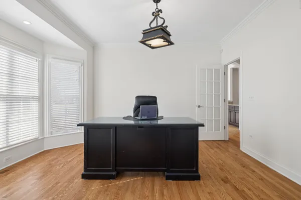 a view of a workspace with furniture and a window