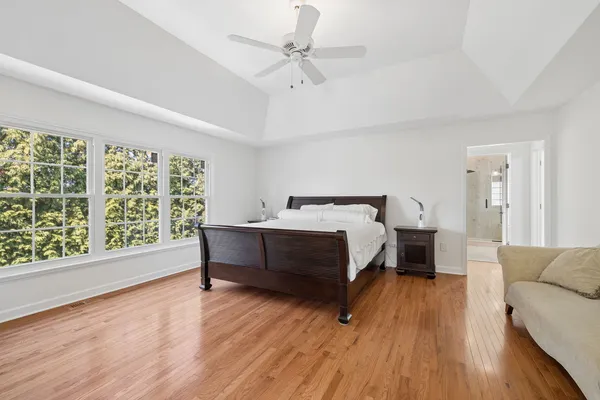 a spacious bathroom with a tub sink shower and mirror