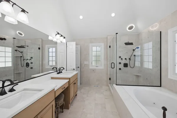 a bathroom with a tub sink and mirror