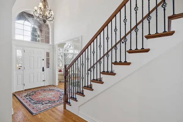a view of entryway and hall with wooden floor