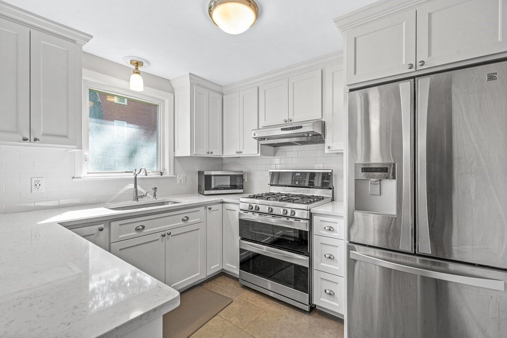 10 Winslow Road Natick, MA 01760 - Photo 5 of 20 a kitchen with stainless steel appliances white cabinets and a refrigerator
