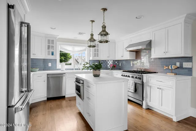 a dining room with furniture window and wooden floor