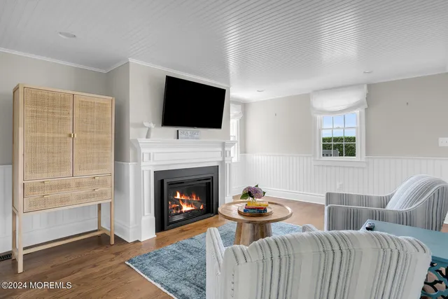 a bathroom with a toilet a sink a mirror and a window