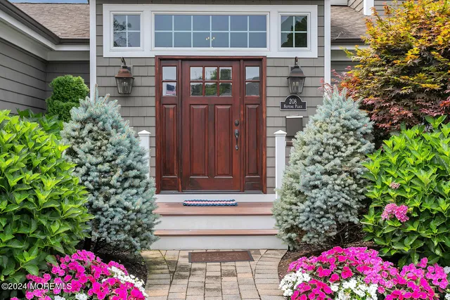 a living room with couches a flat screen tv and kitchen view