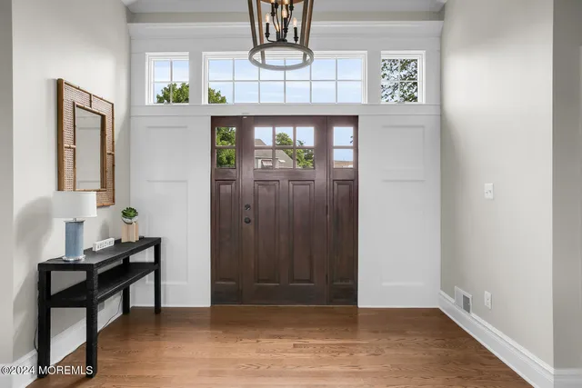 a living room with furniture a flat screen tv and a large window