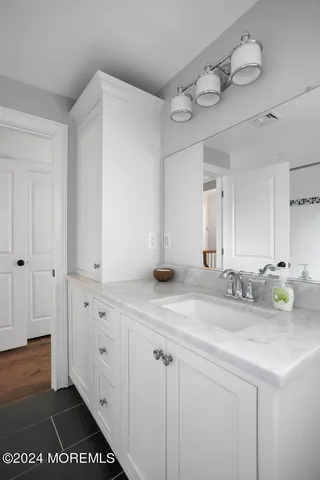 a front view of a house with a garden and plants