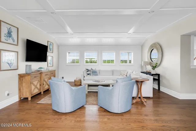 a living room with furniture and view of kitchen