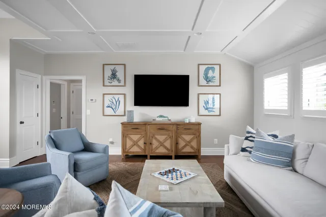 a bedroom with a bed lamp and a large window