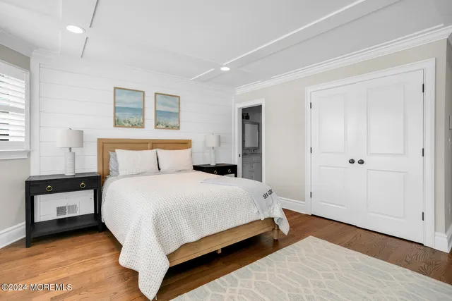 a bedroom with a bed and a night stand