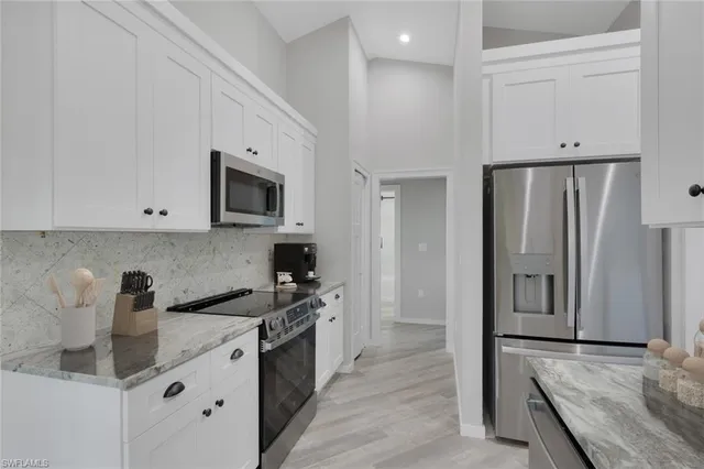 a kitchen with stainless steel appliances a refrigerator stove and sink