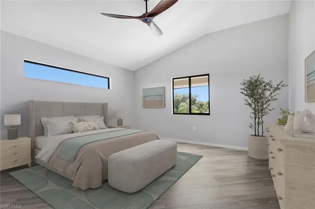 a bedroom with a bed and a potted plant