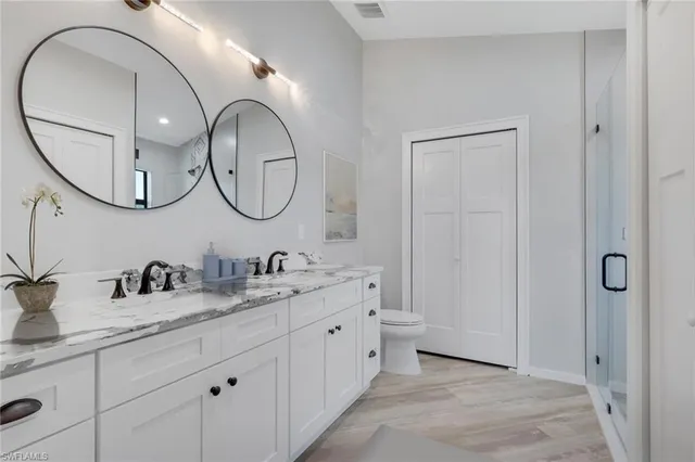 a bathroom with a double vanity sink and a mirror