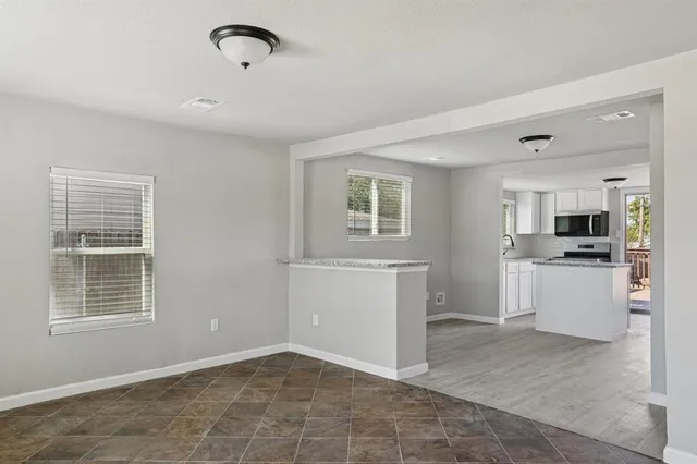 a kitchen with stainless steel appliances granite countertop a stove and a refrigerator