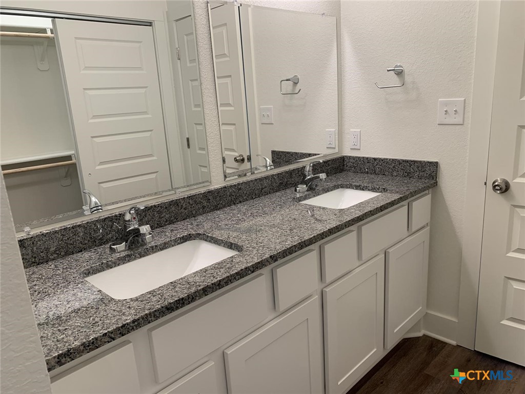 1862 Royal Loop Belton, TX 76513 - Photo 13 of 26 a bathroom with a granite countertop sink and a mirror