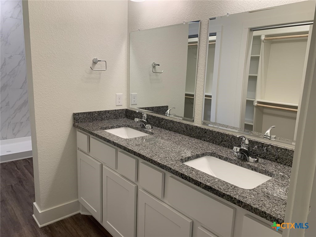1862 Royal Loop Belton, TX 76513 - Photo 15 of 26 a bathroom with a granite countertop sink and a mirror