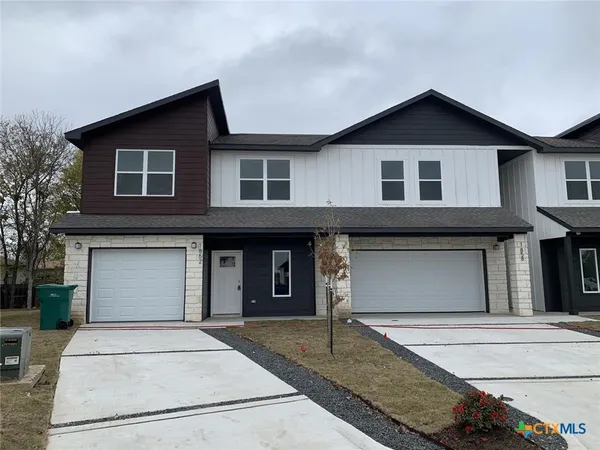 a front view of a house with garage