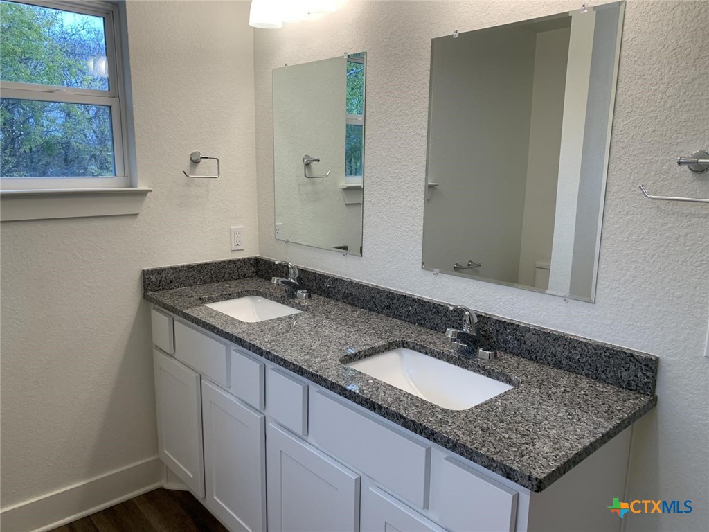 1862 Royal Loop Belton, TX 76513 - Photo 22 of 26 a bathroom with a granite countertop sink and a mirror