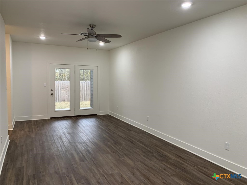1862 Royal Loop Belton, TX 76513 - Photo 3 of 26 a view of an empty room with a window and wooden floor