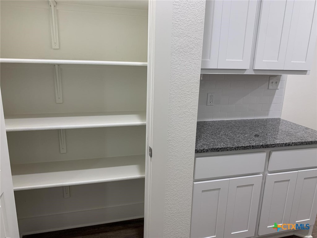 1862 Royal Loop Belton, TX 76513 - Photo 7 of 26 a kitchen with a white cabinets and a refrigerator