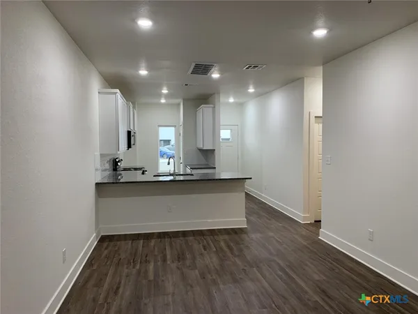 a view of room with wooden floor
