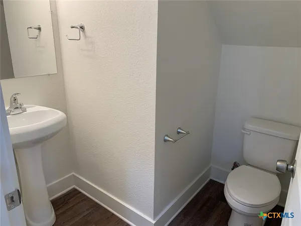 a bathroom with a sink toilet and a mirror