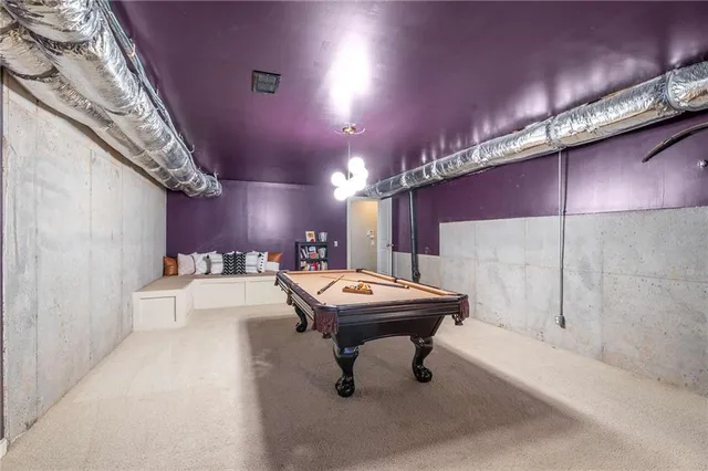 an aerial view of a house with a yard and trees all around