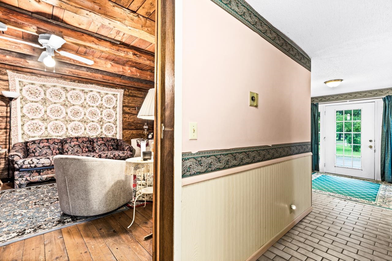 3723 Birchwood Road Kettle River, MN 55757 - Photo 20 of 48 Corridor featuring a wainscoted wall, beam ceiling, and wooden walls