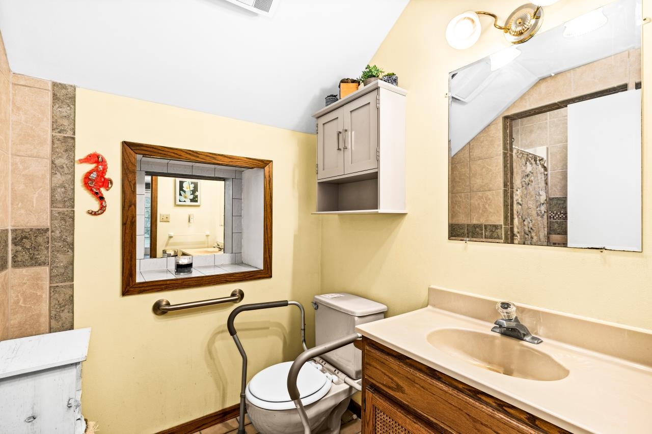 3723 Birchwood Road Kettle River, MN 55757 - Photo 21 of 48 Bathroom with vanity, a tile shower, and vaulted ceiling