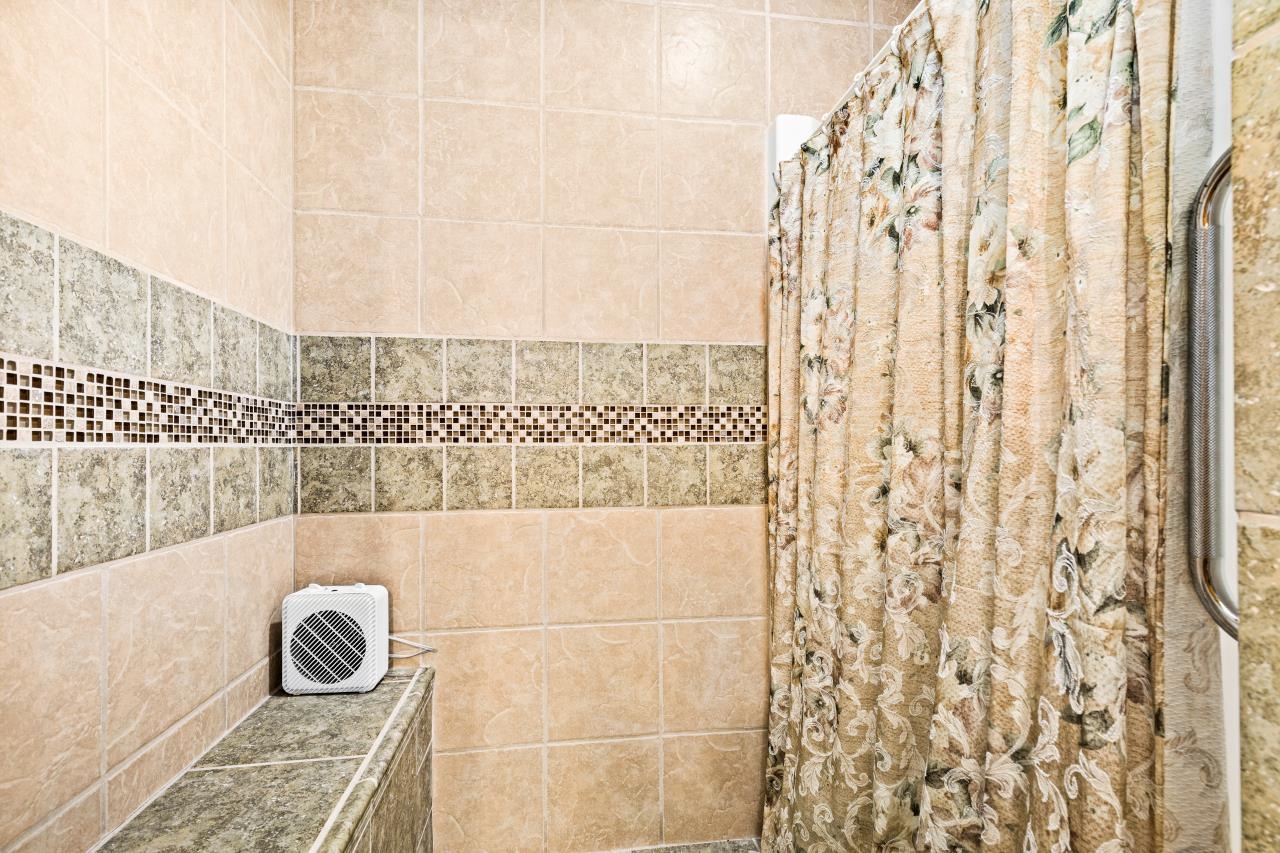 3723 Birchwood Road Kettle River, MN 55757 - Photo 22 of 48 Bathroom with tiled shower and tile walls