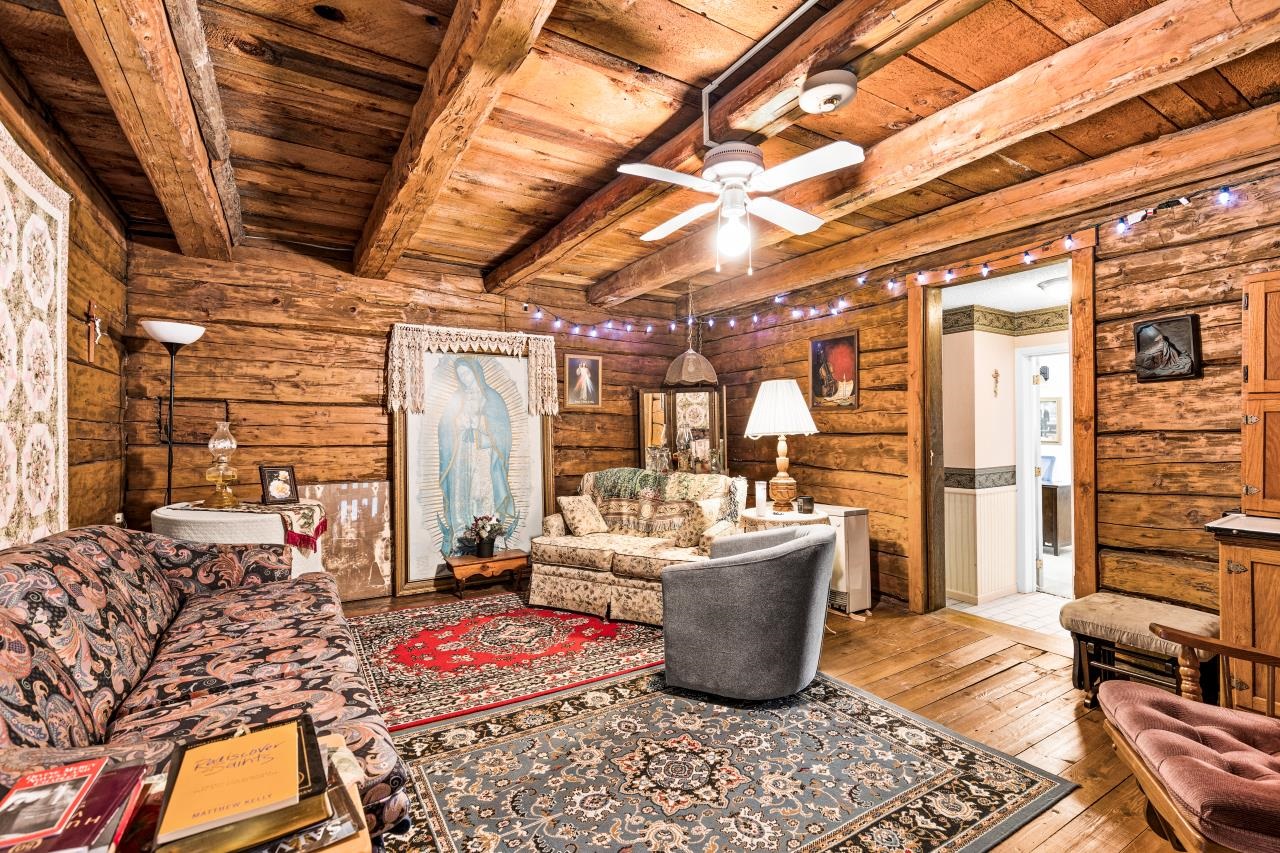 3723 Birchwood Road Kettle River, MN 55757 - Photo 24 of 48 Living room with hardwood / wood-style floors, a wooden ceiling with exposed beams, a ceiling fan, and log walls
