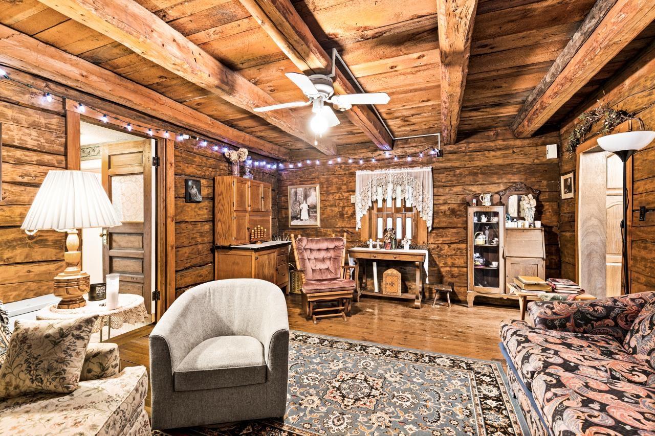 3723 Birchwood Road Kettle River, MN 55757 - Photo 25 of 48 Living room with a wood ceiling with exposed beams, wood finished floors, a ceiling fan, and log walls