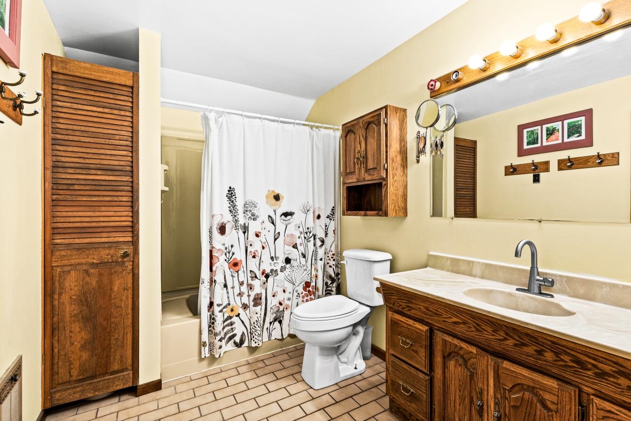 3723 Birchwood Road Kettle River, MN 55757 - Photo 27 of 48 Full bathroom with vanity, shower / bath combo with shower curtain, and light tile patterned floors