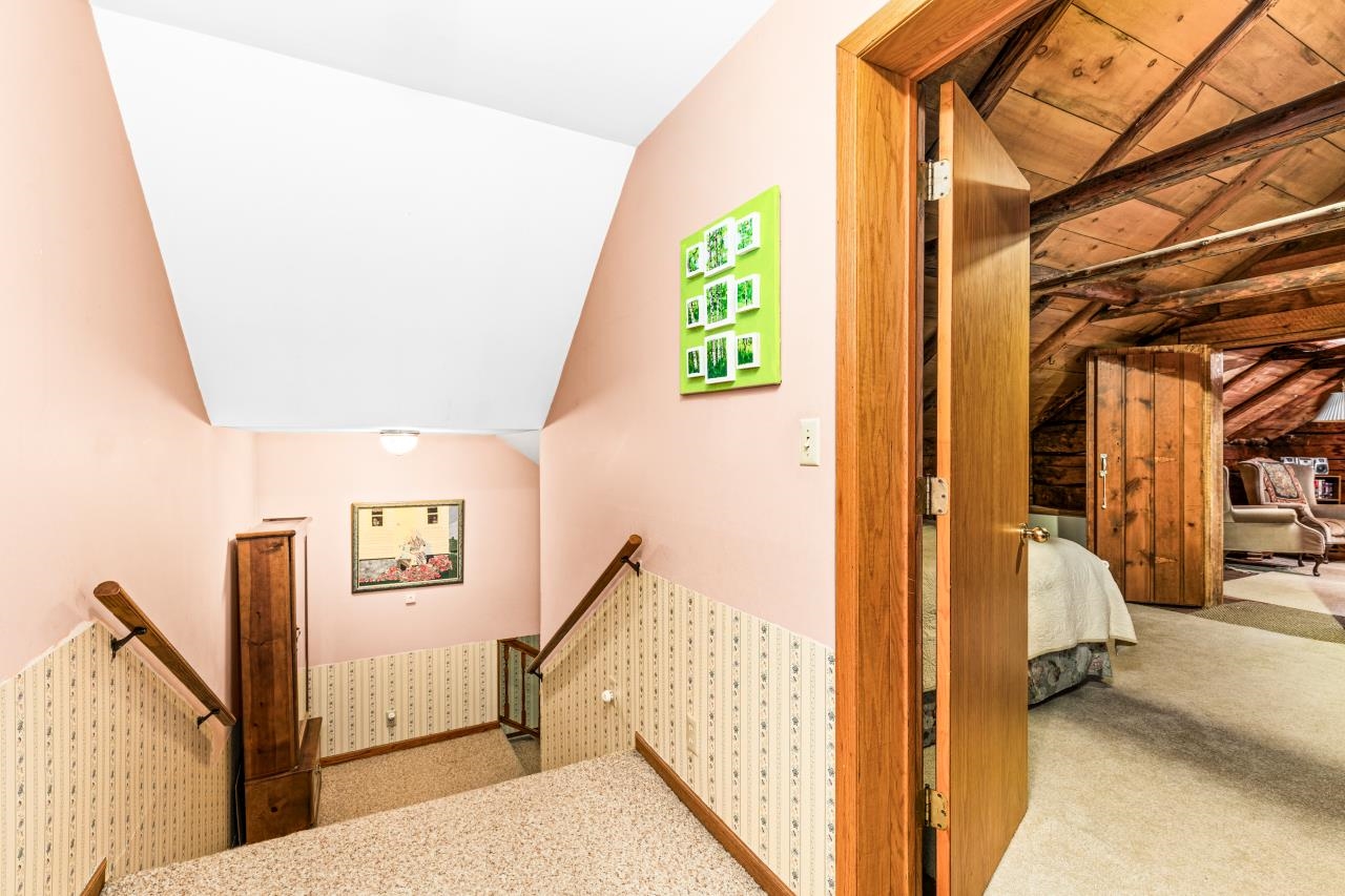 3723 Birchwood Road Kettle River, MN 55757 - Photo 31 of 48 Staircase with vaulted ceiling and carpet