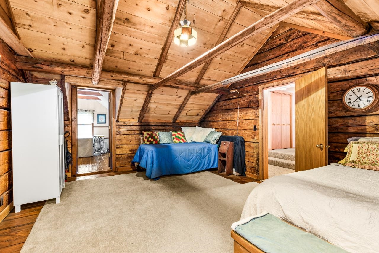 3723 Birchwood Road Kettle River, MN 55757 - Photo 34 of 48 Carpeted bedroom with wooden walls, wood ceiling, a ceiling fan, and wood finished floors