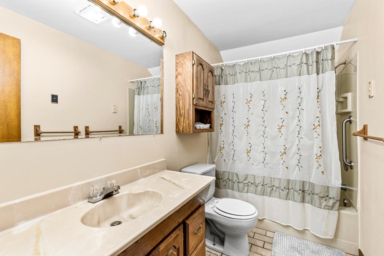 3723 Birchwood Road Kettle River, MN 55757 - Photo 44 of 48 Full bath with shower / bathtub combination with curtain, vanity, and light tile patterned floors