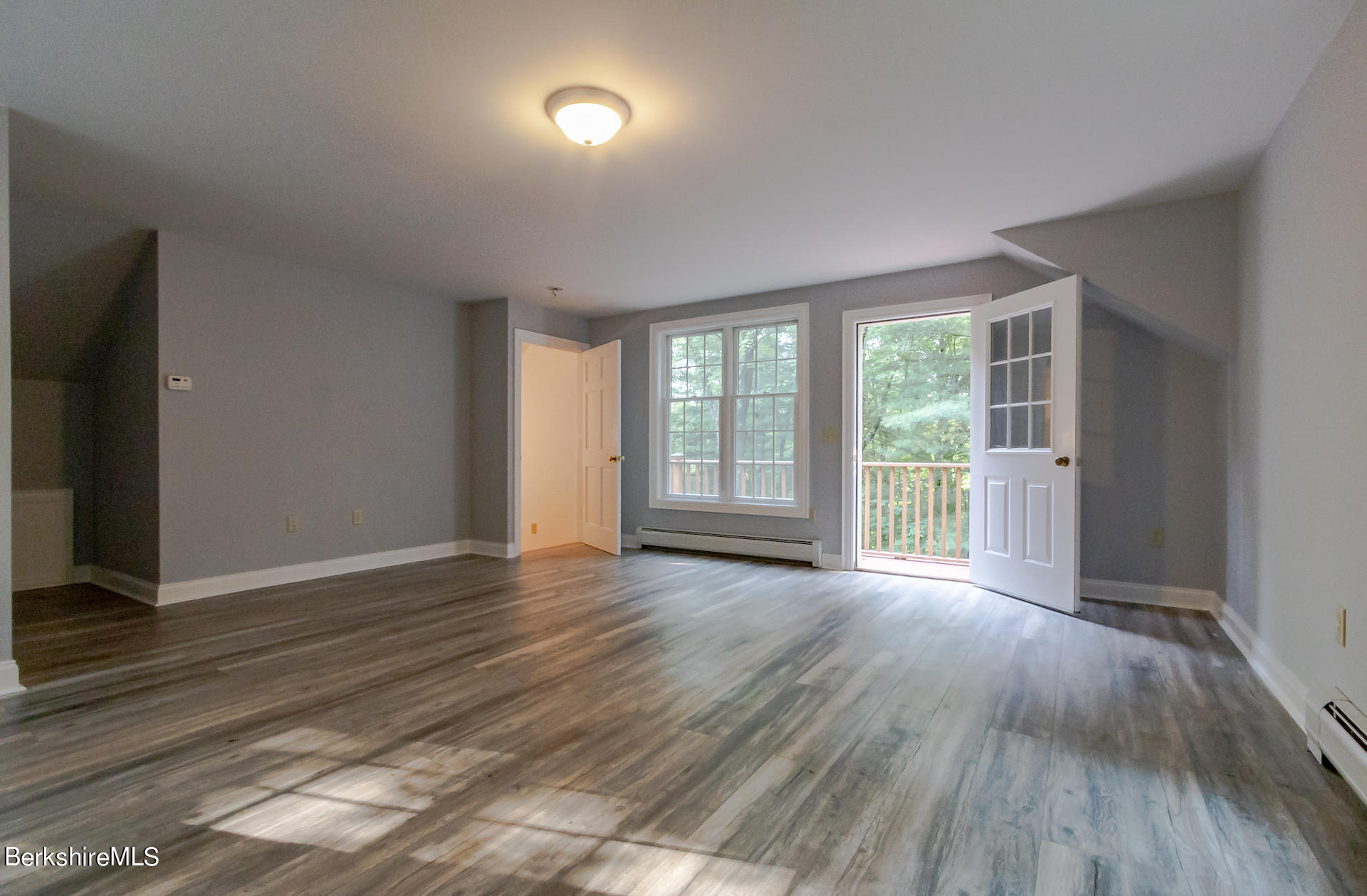 6 Oxbow Road Egremont, MA 01230 - Photo 33 of 42 a view of an empty room with wooden floor and a window