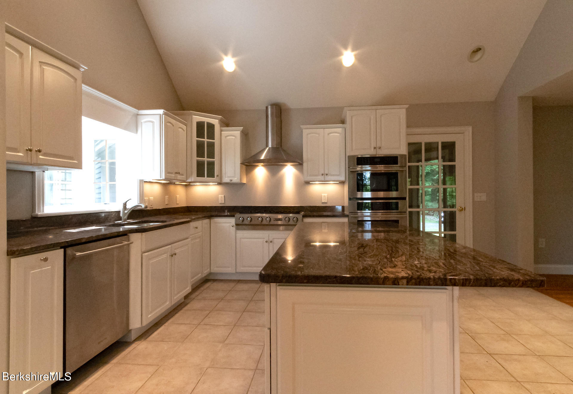 6 Oxbow Road Egremont, MA 01230 - Photo 9 of 42 a kitchen with kitchen island granite countertop a stove a sink a counter space and cabinets