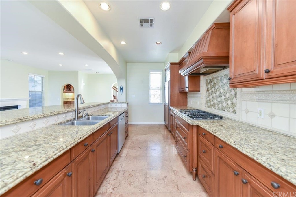 19 Ferrand Newport Coast, CA 92657 - Photo 28 of 74 a large kitchen with stainless steel appliances granite countertop a sink and cabinets