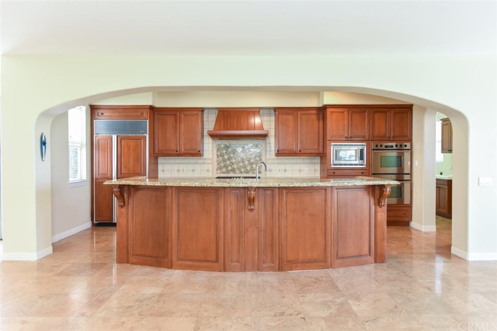 19 Ferrand Newport Coast, CA 92657 - Photo 29 of 74 a kitchen with granite countertop a refrigerator and cabinets
