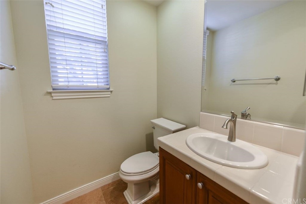 19 Ferrand Newport Coast, CA 92657 - Photo 64 of 74 a bathroom with a sink a toilet and a mirror