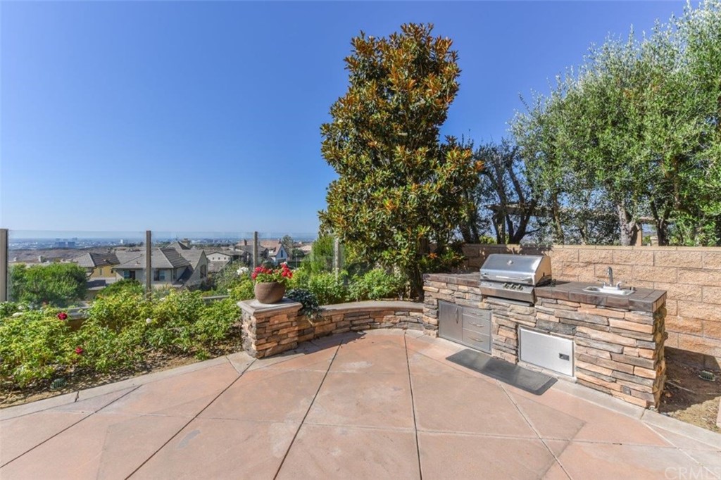 19 Ferrand Newport Coast, CA 92657 - Photo 66 of 74 a view of a terrace with a bench and trees