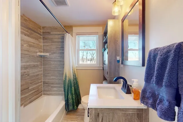 a bathroom with a bathtub and shower
