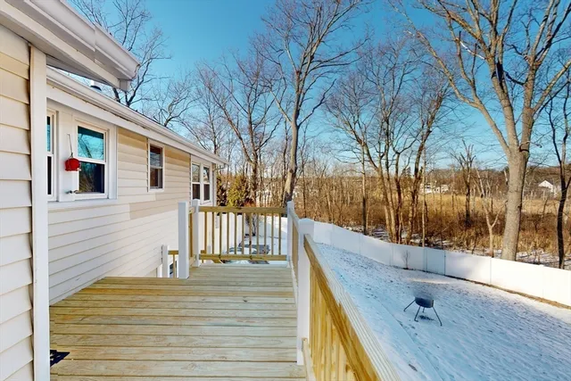 a view of a balcony with wooden floor and fence