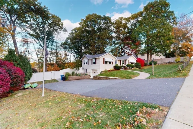a view of a house with a yard and garage