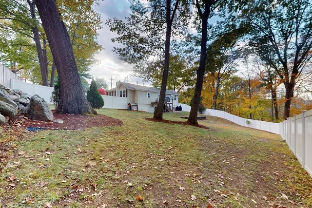 a view of a tree in front of a house