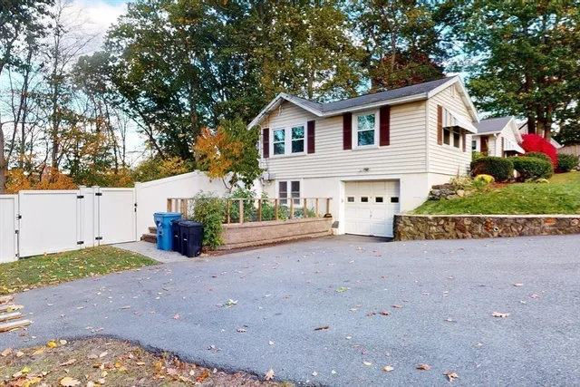 a view of a house with a yard and garage