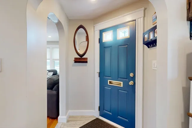 a view of a hallway with wooden floor and closet