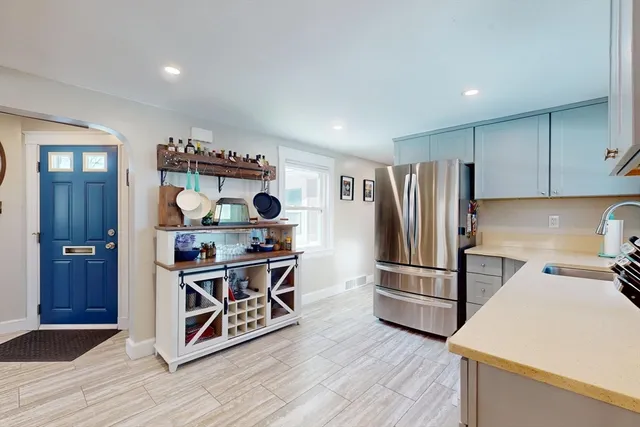 a kitchen with stainless steel appliances a stove a refrigerator and wooden cabinets