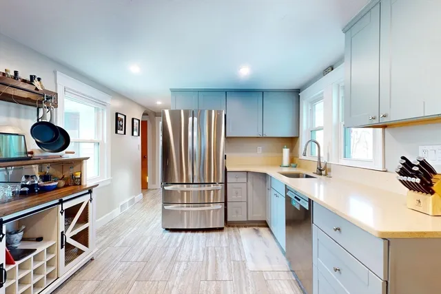 a kitchen with stainless steel appliances a stove a sink and a refrigerator