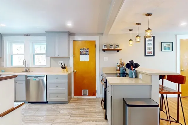 a kitchen with stainless steel appliances granite countertop a sink stove and cabinets